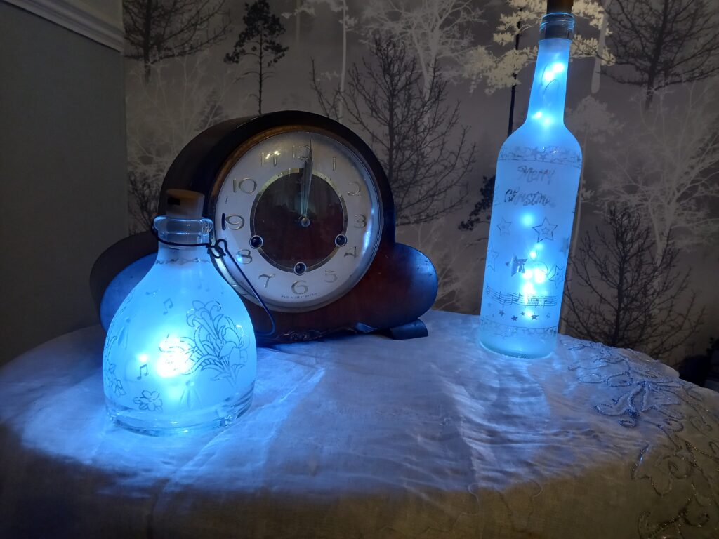 Etched glass bottles with internal fairy lights.